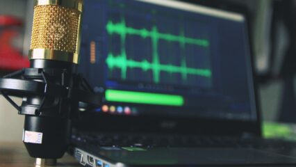 gold condenser microphone near laptop computer